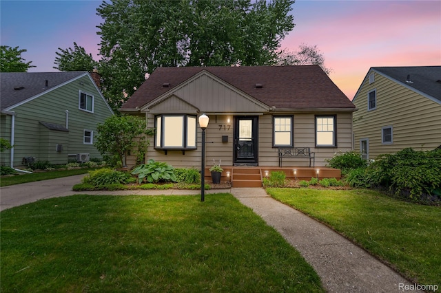 717 N Vermont Ave, Royal Oak, MI 48067 - bungalow-style house with board and batten siding, a lawn, and a shingled roof