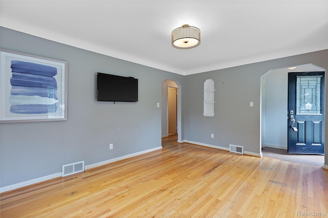 717 N Vermont Ave, Royal Oak, MI 48067 - spare room with arched walkways, baseboards, and wood finished floors