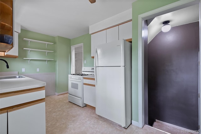 717 N Vermont Ave, Royal Oak, MI 48067 - kitchen featuring white appliances, open shelves, a sink, white cabinets, and wainscoting