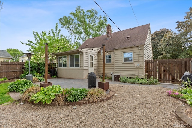 717 N Vermont Ave, Royal Oak, MI 48067 - back of house featuring a gate, a patio, a chimney, and a shingled roof