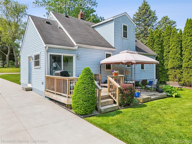 3414 Gregory Rd, Lake Orion, MI 48359 - back of property with roof with shingles, a patio, a lawn, and a chimney