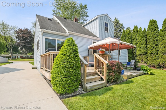 3414 Gregory Rd, Lake Orion, MI 48359 - view of front of property with a shingled roof, a wooden deck, and a front lawn