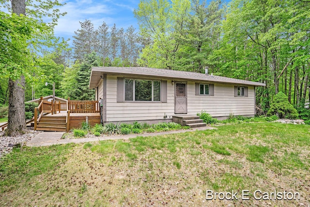 3609 S Hilton Park Rd, Fruitport, MI 49415 - view of front facade with a deck and a front yard