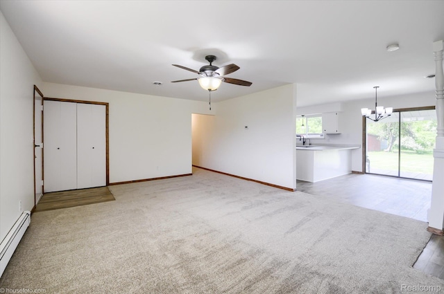 2680 N Lake George Rd, Metamora, MI 48455 - unfurnished living room featuring a baseboard radiator, a chandelier, ceiling fan, and baseboards