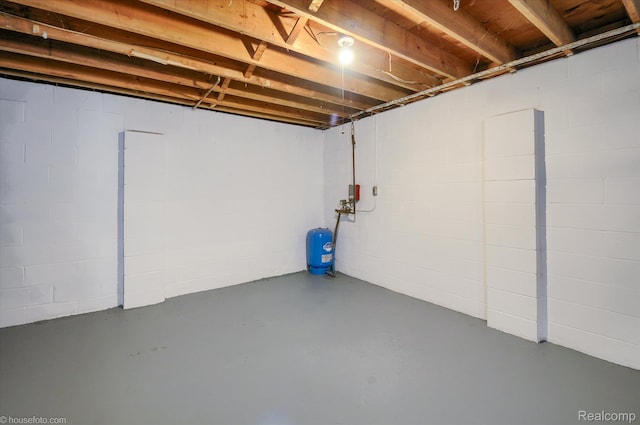 2680 N Lake George Rd, Metamora, MI 48455 - unfinished below grade area with a water pressure tank and concrete block wall