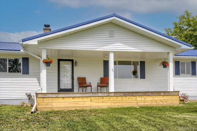 2680 N Lake George Rd, Metamora, MI 48455 - view of front facade featuring a porch, a chimney, metal roof, and a front yard