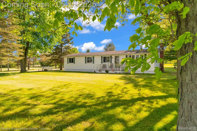 3889 Wadhams Rd, Clyde, MI 48049 - rear view of property with a lawn and a wooden deck