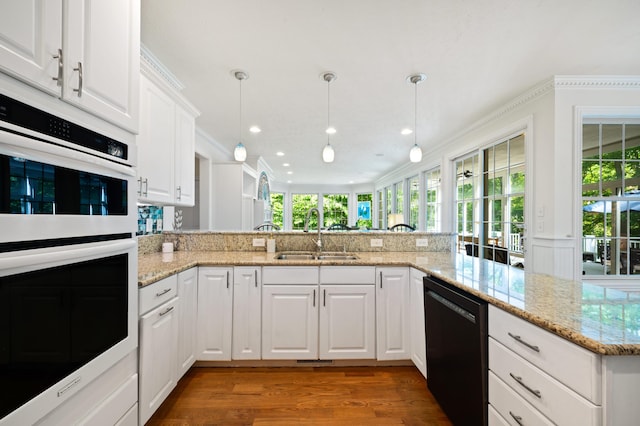 1796 Stockbridge Path, Saint Joseph, MI 49085 - kitchen featuring black dishwasher, double oven, a sink, wood finished floors, and light stone countertops