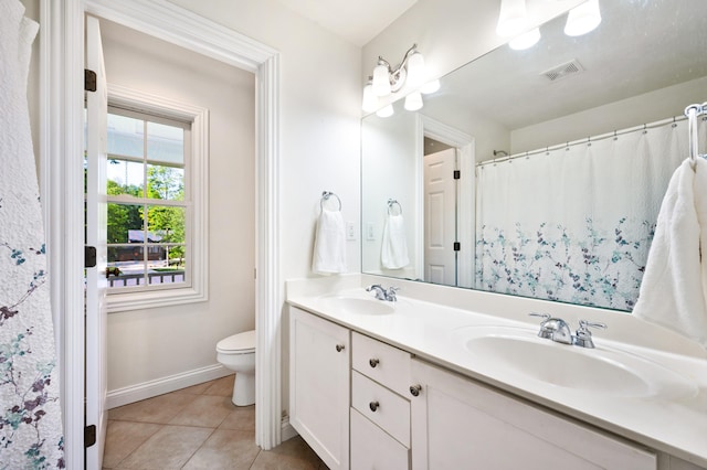 1796 Stockbridge Path, Saint Joseph, MI 49085 - full bathroom featuring toilet, double vanity, baseboards, and tile patterned floors