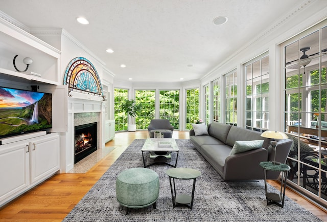 1796 Stockbridge Path, Saint Joseph, MI 49085 - living room with ornamental molding, light wood finished floors, a premium fireplace, and recessed lighting