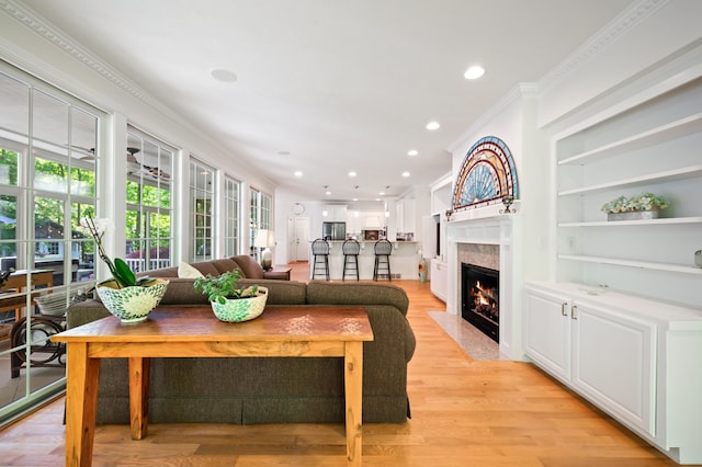 1796 Stockbridge Path, Saint Joseph, MI 49085 - living area with a premium fireplace, light wood finished floors, recessed lighting, crown molding, and built in features
