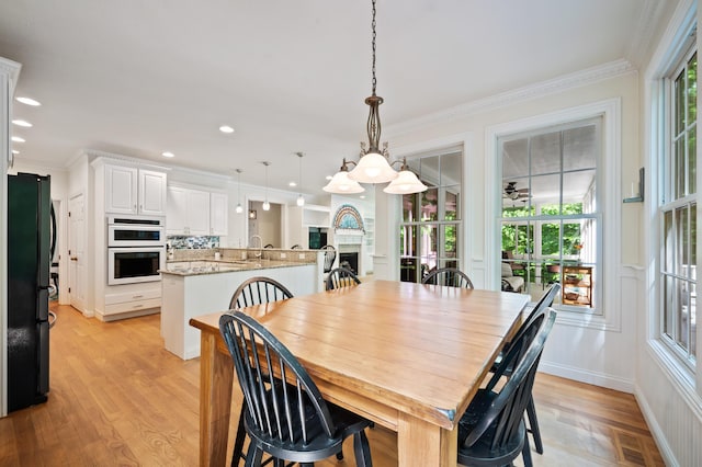 1796 Stockbridge Path, Saint Joseph, MI 49085 - dining area featuring light wood-style floors, ornamental molding, recessed lighting, and a fireplace
