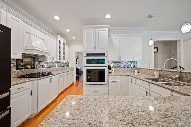 1796 Stockbridge Path, Saint Joseph, MI 49085 - kitchen with a sink, custom range hood, gas cooktop, white double oven, and white cabinets
