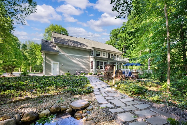 1796 Stockbridge Path, Saint Joseph, MI 49085 - rear view of property featuring a deck and roof with shingles