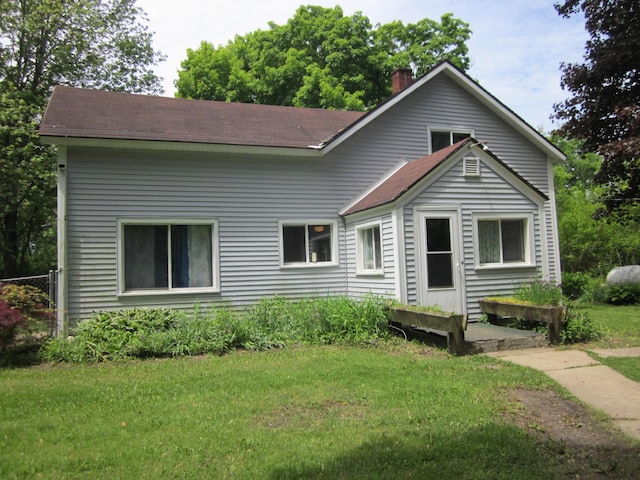 28131 66th St, Bangor, MI 49013 - view of front facade with a chimney, a front lawn, and a shingled roof