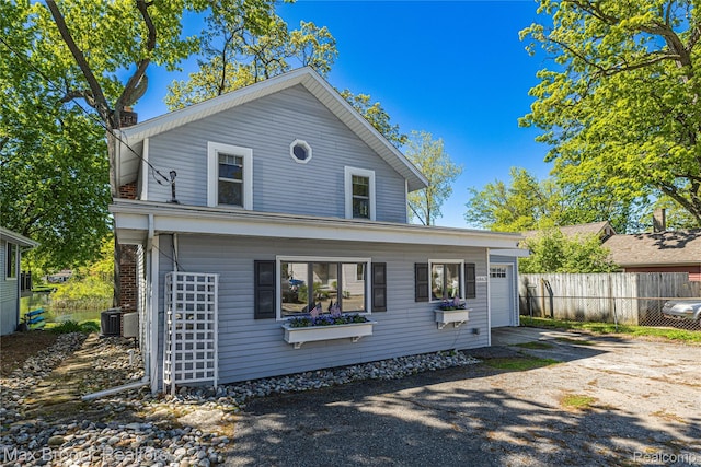6863 Brightwood Ct, Waterford, MI 48327 - view of front of home featuring driveway, an attached garage, and cooling unit