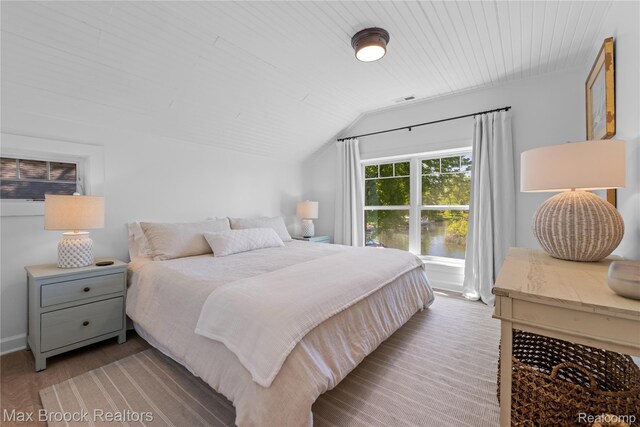 6863 Brightwood Ct, Waterford, MI 48327 - bedroom with vaulted ceiling, wood finished floors, and baseboards