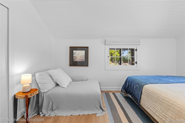 6863 Brightwood Ct, Waterford, MI 48327 - bedroom featuring wood finished floors, baseboards, and lofted ceiling