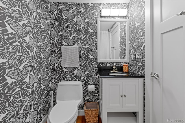 6863 Brightwood Ct, Waterford, MI 48327 - bathroom featuring wallpapered walls, vanity, and toilet