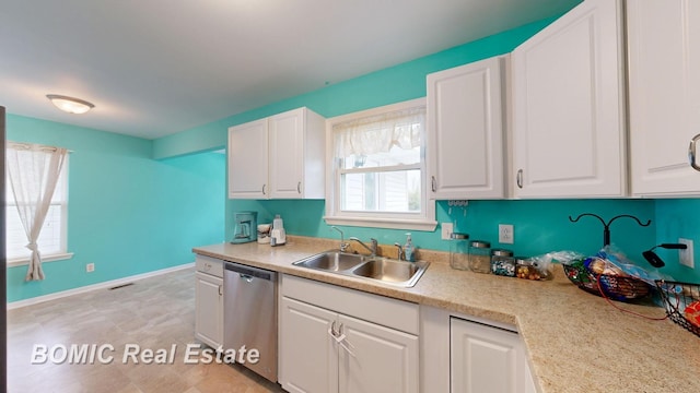 6128 Barnes Rd, Millington, MI 48746 - kitchen featuring dishwasher, a sink, white cabinetry, and light countertops