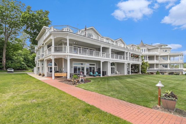 6180 Murray Rd Unit 301, Whitehall, MI 49461 - back of property featuring a balcony, a lawn, and a patio area