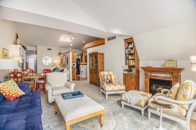 6180 Murray Rd Unit 301, Whitehall, MI 49461 - living area featuring lofted ceiling, ceiling fan, a glass covered fireplace, and light carpet