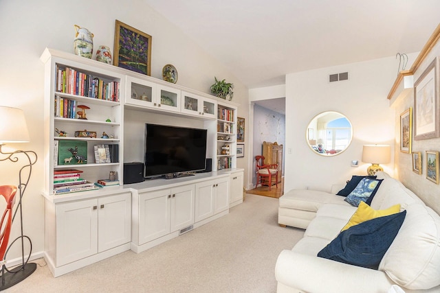 6180 Murray Rd Unit 301, Whitehall, MI 49461 - living room featuring light colored carpet and vaulted ceiling