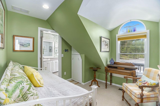 6180 Murray Rd Unit 301, Whitehall, MI 49461 - bedroom with vaulted ceiling, baseboards, light carpet, and ensuite bath
