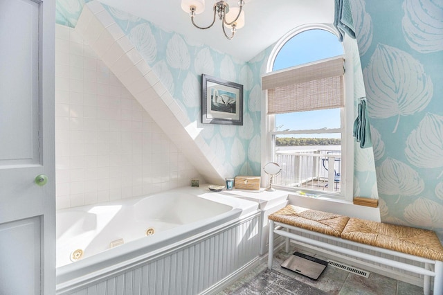 6180 Murray Rd Unit 301, Whitehall, MI 49461 - bathroom with a tub with jets, wallpapered walls, a chandelier, and vaulted ceiling