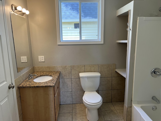 911 Muskegon Ave NW, Grand Rapids, MI 49504 - full bath with vanity, tile walls, toilet, tile patterned floors, and shower / bath combination
