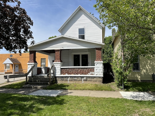911 Muskegon Ave NW, Grand Rapids, MI 49504 - view of front of property with a porch and brick siding