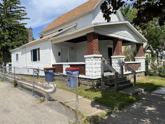 911 Muskegon Ave NW, Grand Rapids, MI 49504 - view of front of home featuring covered porch, a chimney, and roof with shingles