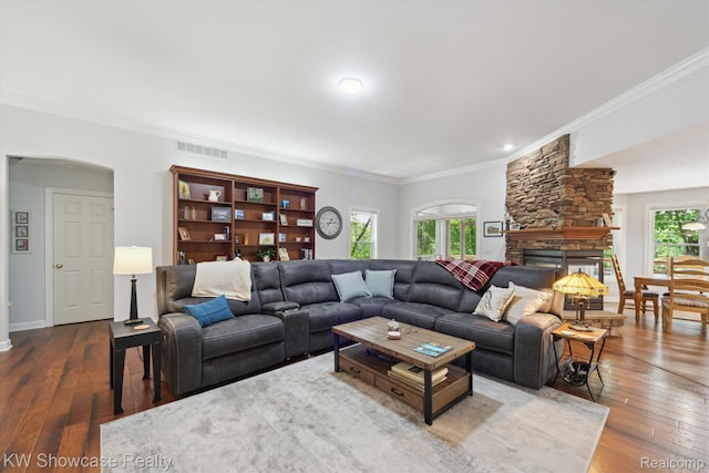 9120 Pineview Lake Dr, Linden, MI 48451 - living area featuring crown molding, wood-type flooring, arched walkways, a fireplace, and baseboards