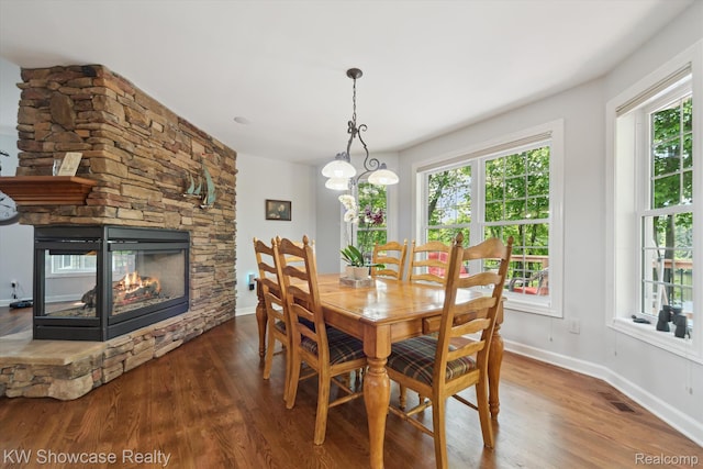 9120 Pineview Lake Dr, Linden, MI 48451 - dining room with wood finished floors, healthy amount of natural light, and a fireplace