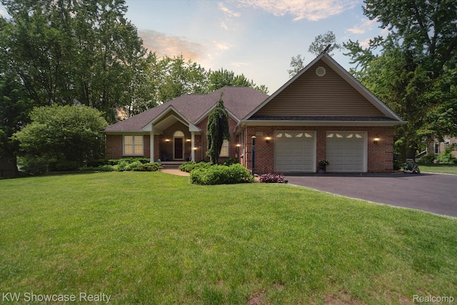 9120 Pineview Lake Dr, Linden, MI 48451 - ranch-style house featuring asphalt driveway, an attached garage, brick siding, and a front lawn