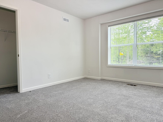 2827 Green Acres Dr, Mulliken, MI 48861 - unfurnished bedroom featuring baseboards, carpet, and a closet