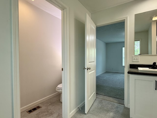 2827 Green Acres Dr, Mulliken, MI 48861 - bathroom featuring toilet, vanity, and baseboards
