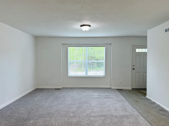 2827 Green Acres Dr, Mulliken, MI 48861 - empty room with carpet, baseboards, and a textured ceiling
