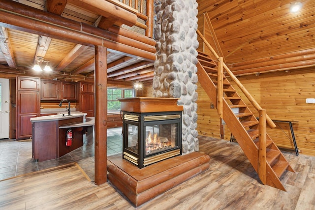1750 Fox Rd, Jackson, MI 49201 - kitchen featuring wood ceiling, light wood-type flooring, light countertops, a fireplace, and a kitchen island with sink
