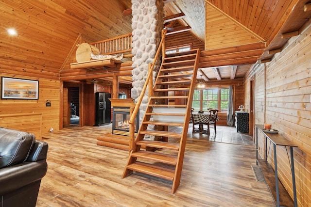 1750 Fox Rd, Jackson, MI 49201 - staircase featuring wooden ceiling, high vaulted ceiling, wooden walls, and hardwood / wood-style floors