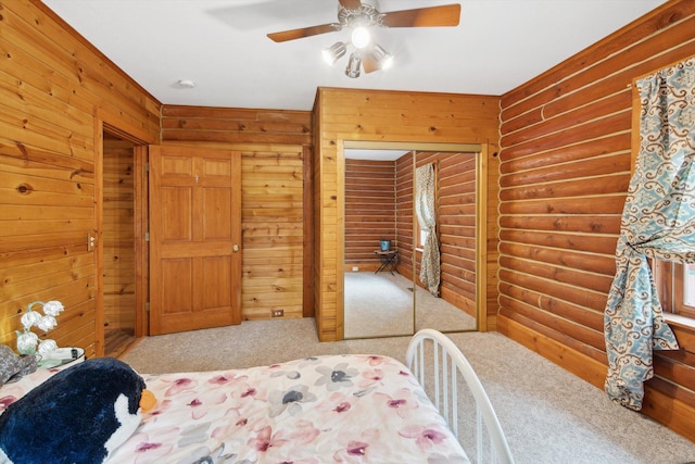 1750 Fox Rd, Jackson, MI 49201 - bedroom featuring carpet flooring, log walls, ceiling fan, and wooden walls