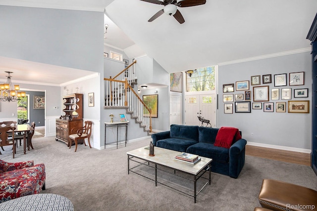 5200 Bridge Trl W, Commerce Twp, MI 48382 - carpeted living room with high vaulted ceiling, stairway, a ceiling fan, a chandelier, and plenty of natural light
