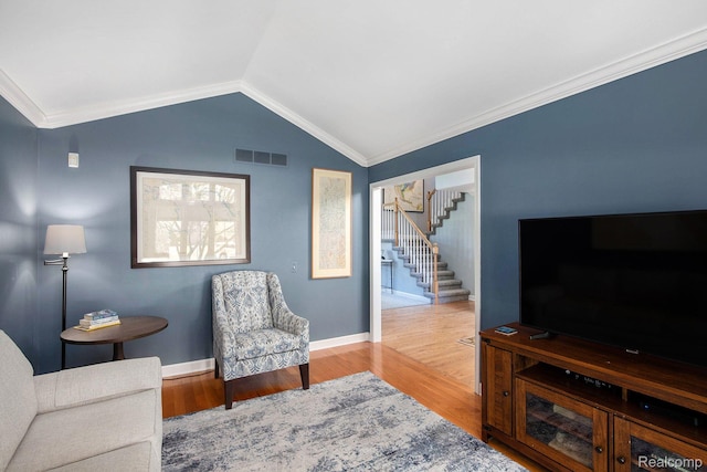 5200 Bridge Trl W, Commerce Twp, MI 48382 - living area with stairway, wood finished floors, lofted ceiling, crown molding, and baseboards