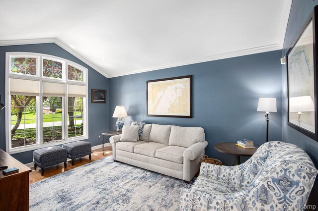 5200 Bridge Trl W, Commerce Twp, MI 48382 - living room featuring lofted ceiling, wood finished floors, baseboards, and crown molding