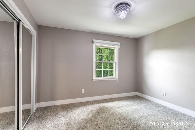 2420 Abbington Dr SE Unit 40, Grand Rapids, MI 49506 - unfurnished bedroom featuring baseboards, carpet flooring, and a closet