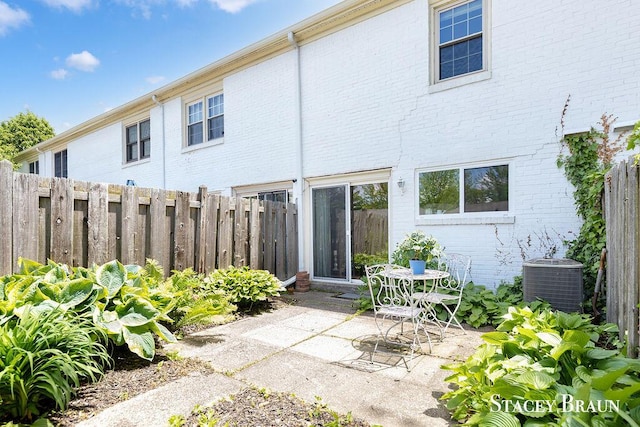 2420 Abbington Dr SE Unit 40, Grand Rapids, MI 49506 - back of property with cooling unit, brick siding, and a patio area
