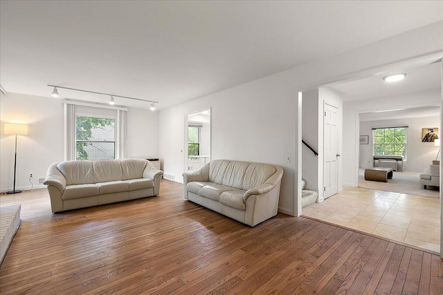 4948 Hardwoods Dr, West Bloomfield, MI 48323 - living area featuring stairs, rail lighting, and hardwood / wood-style flooring