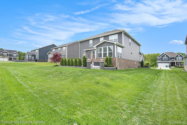 2670 Ironton Dr, Commerce Twp, MI 48382 - back of house featuring brick siding, a residential view, and a lawn