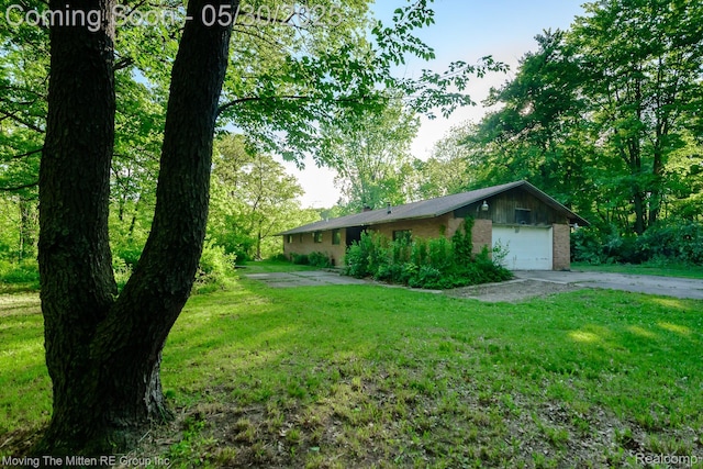 6621 Crane Rd, Ypsilanti, MI 48197 - view of front of property featuring a front lawn, a garage, concrete driveway, and brick siding