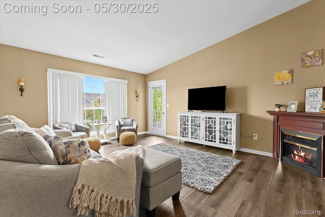 51623 Hale Ln, Chesterfield, MI 48051 - living room with vaulted ceiling, wood finished floors, baseboards, and a glass covered fireplace